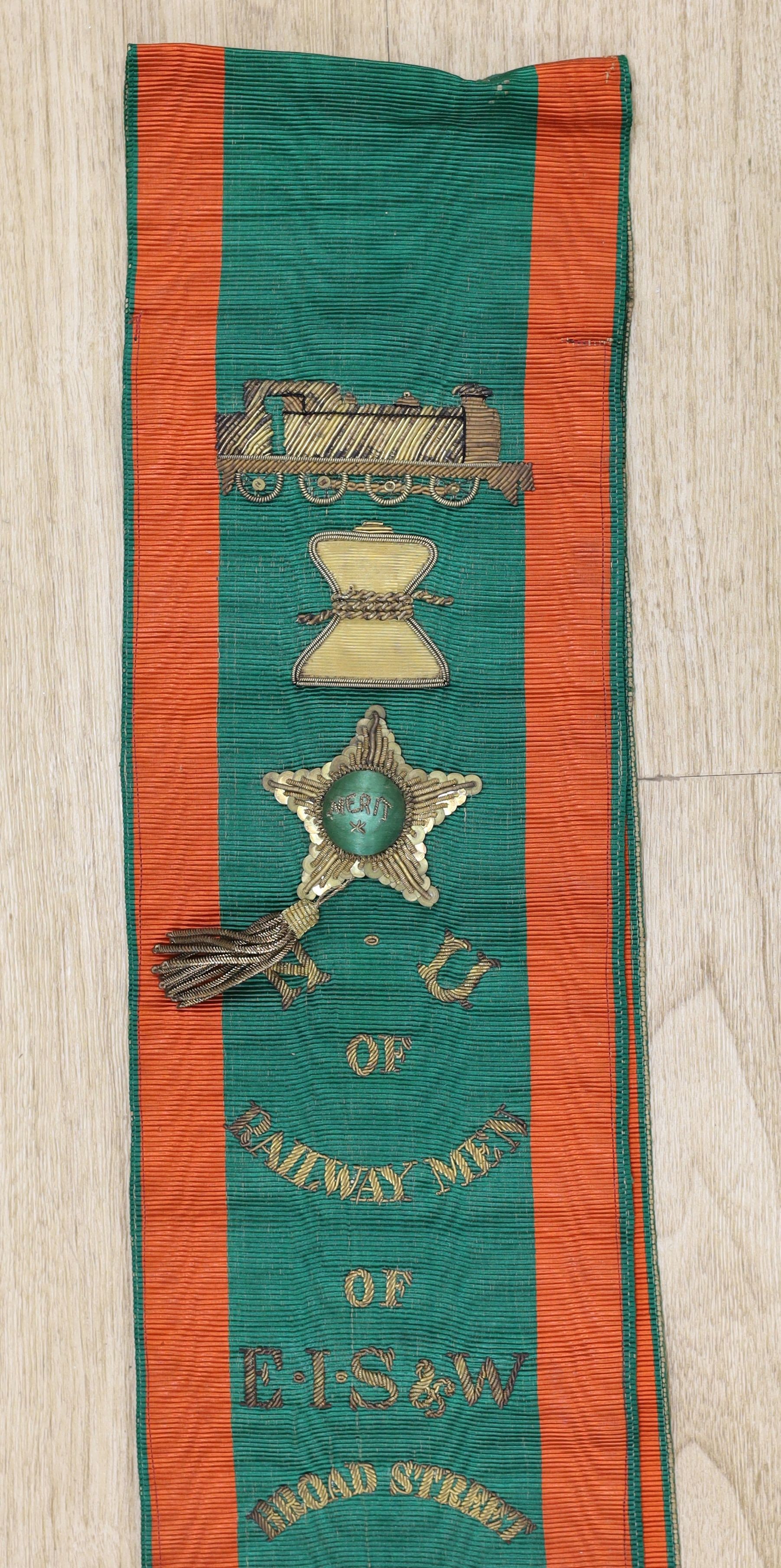 Railway Interest - A metal thread embroidered silk sash inscribed ‘Railway Men of E I S & W, Broad Street Branch - presented to E.J. Foulkes by branch benevolent fund’ - approx 190cm long